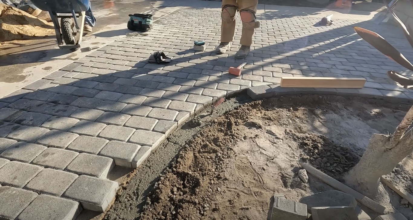 Concrete repair and restoration work in Brownsville showing damaged pavers being replaced with fresh concrete
